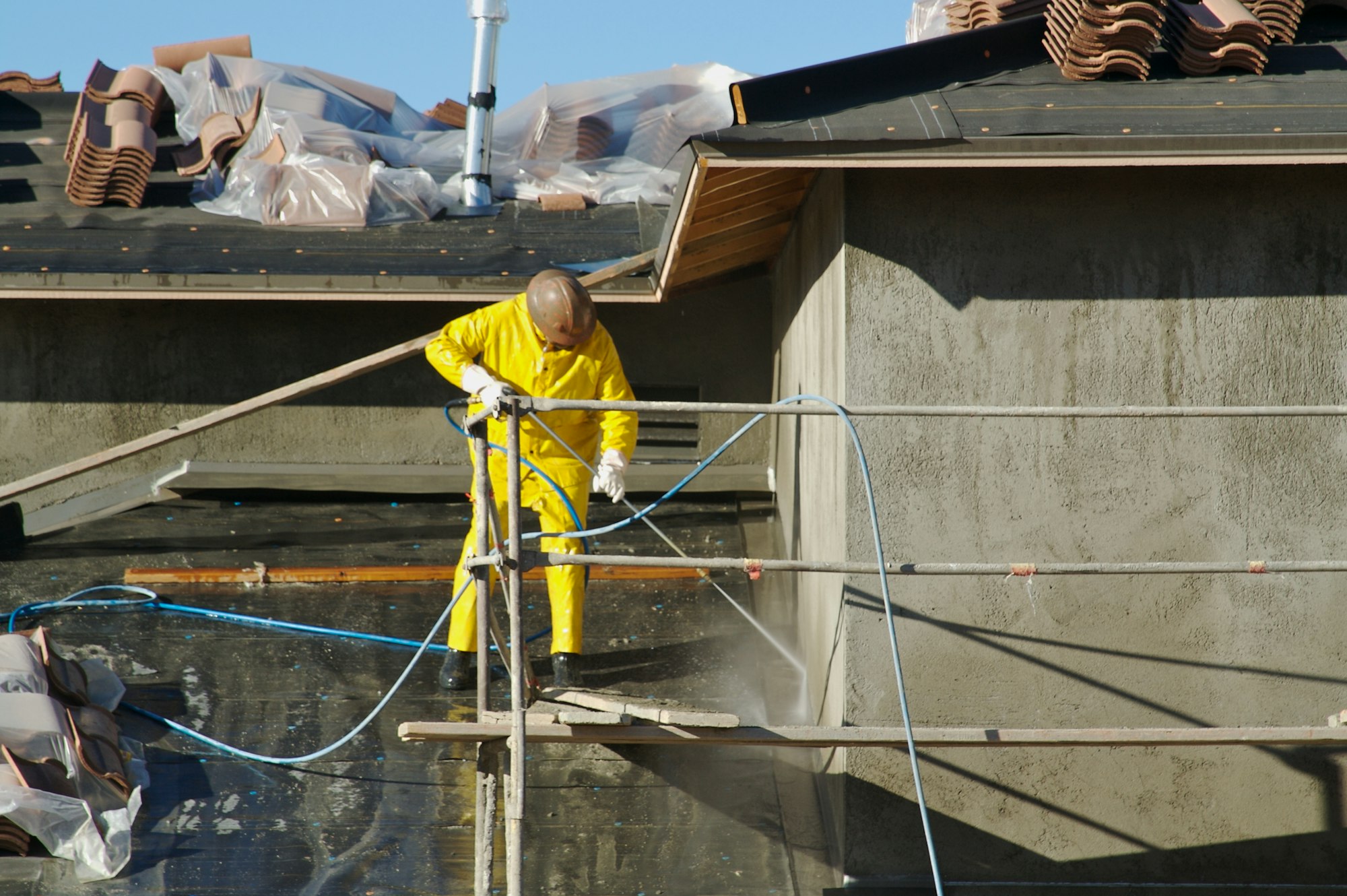 Construction Worker Pressure Washes